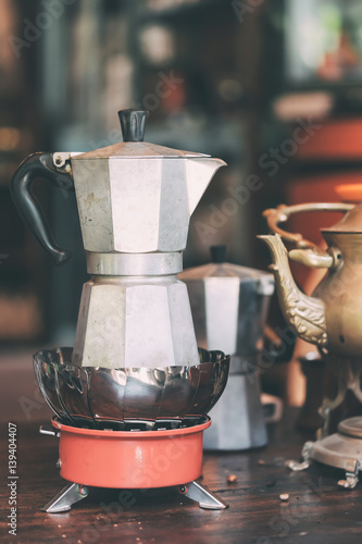 Moka pot manual hand made espresso coffee Maker macchinetta boil steam on little stove.