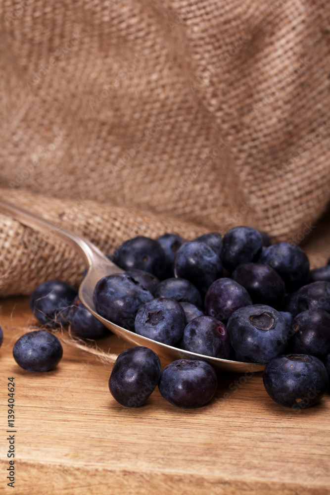 Blueberries and spoon on a rustic background Blueberries and spoon on a rustic background