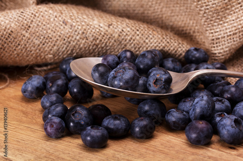 Blueberries and spoon on a rustic background