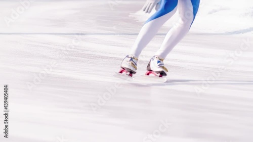 Speed ice skater skating on outdoor race on turn HD slow-motion video. View of professional athlete legs training for winter olympic. Lower body