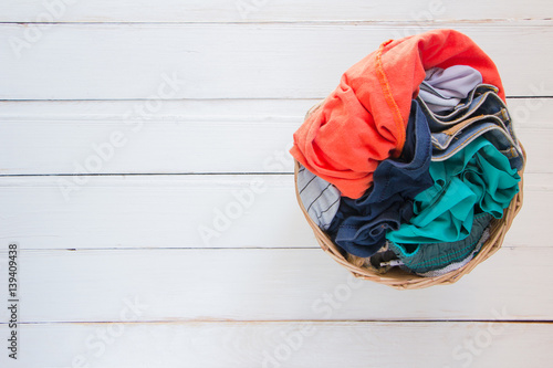 Photos Top view Clothes in a laundry basket on Wood floor