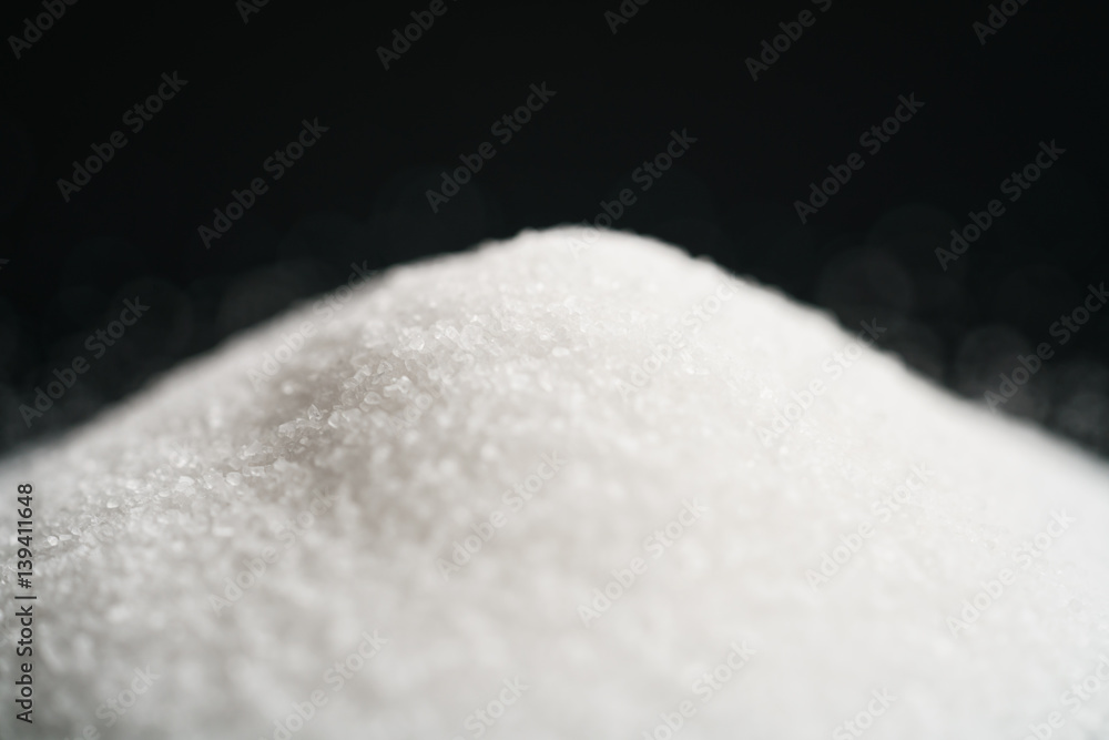 white sugar heap on black background closeup photo, shallow focus white sugar heap on black background closeup photo, shallow focus