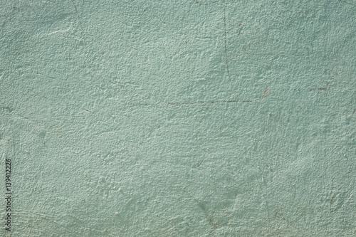 Rough pale green concrete wall background, texture
