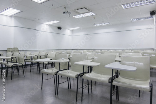Abstract blur school classroom interior with desk background