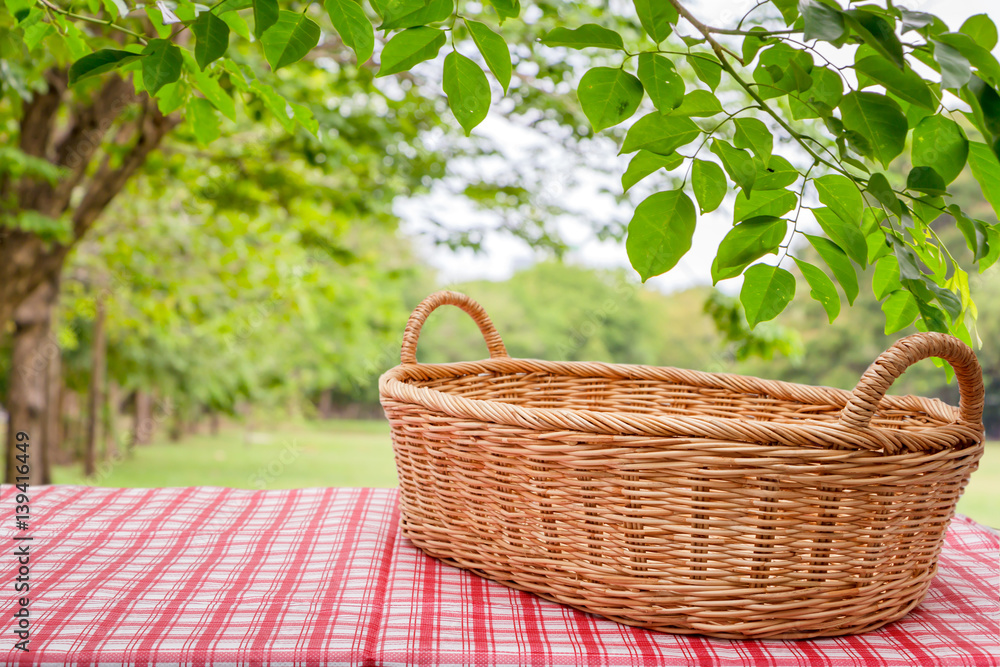 Empty wicker basket on the table with the natural background. Empty wicker basket on the table with the natural background.