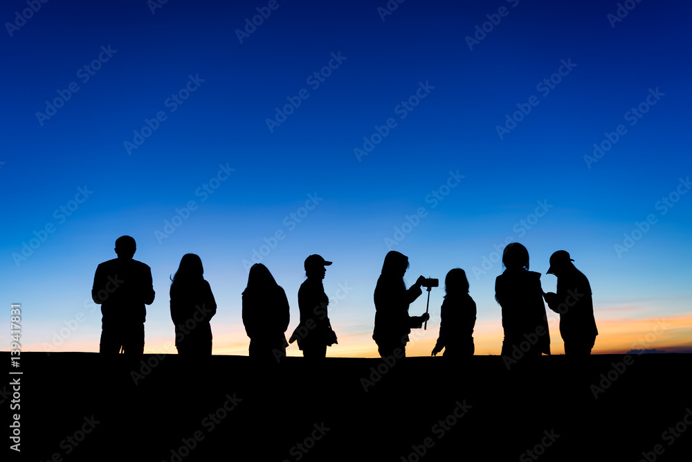 silhouette of group of people in the Sunrise Background.