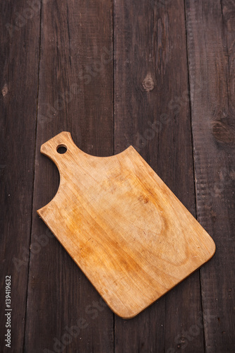 wooden cutting board on a wooden background