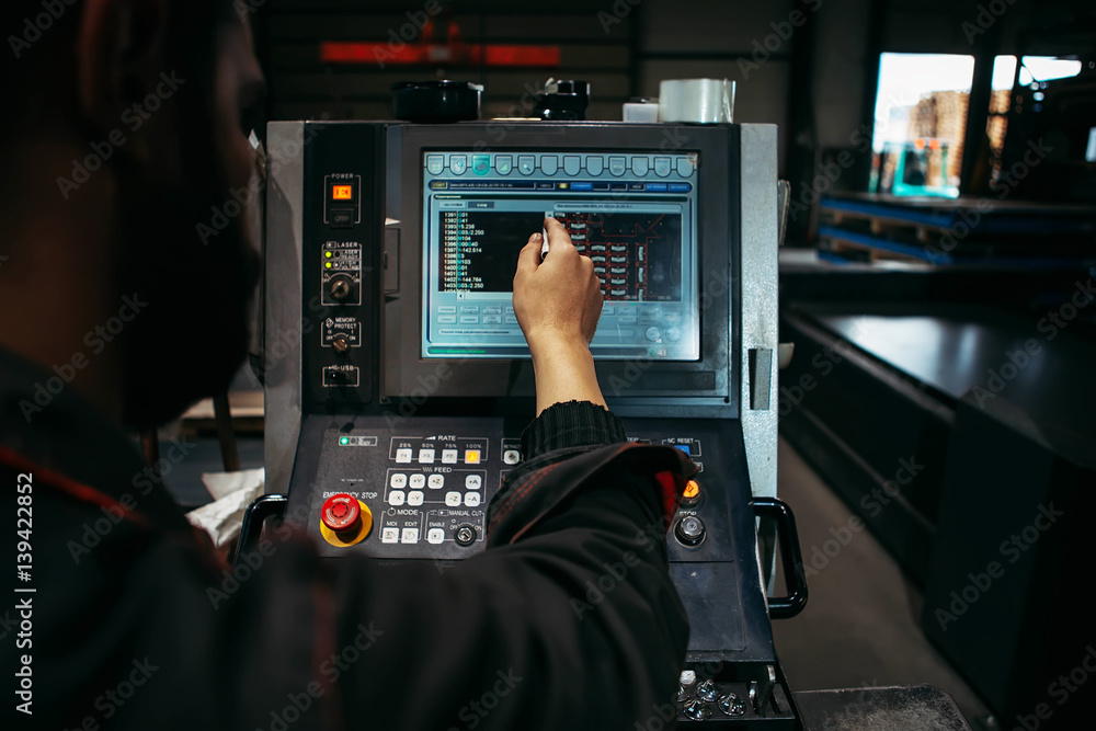 Laser Cutting Machine During operation controlled by Technician Laser Cutting Machine During operation controlled by Technician