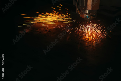 Laser cutting machine cuts the metal with sparks