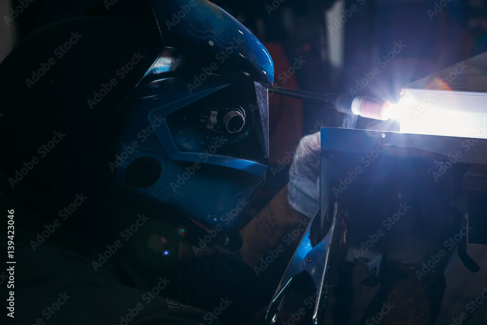 Fototapeta sparks while welder uses torch to welding