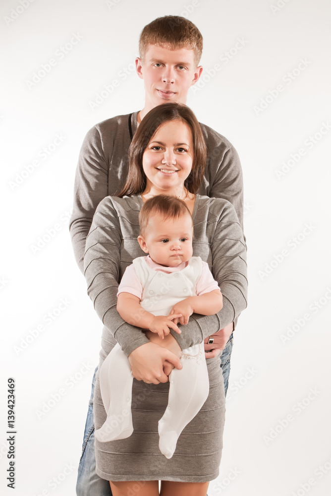 Happy family with child posing on white background Happy family with child posing on white background
