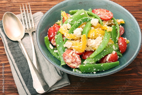 Snow pea salad with feta, tomato and pepper