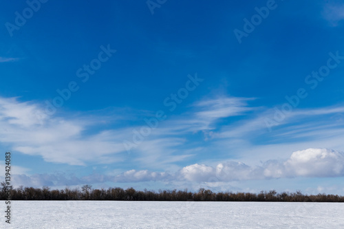 Spring sky over the snowy plain.