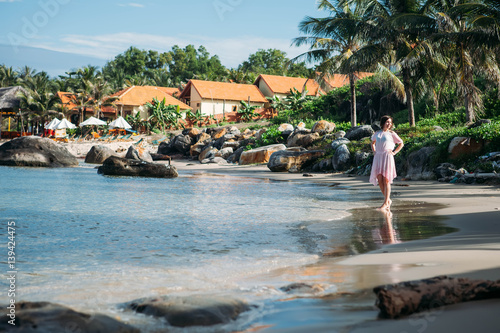 Happy girl walking along tropical beach © Olga