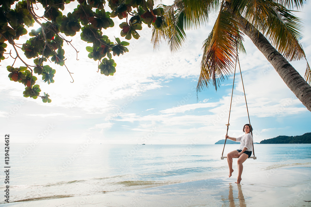 Happy woman on a swing tropical island Happy woman on a swing tropical island