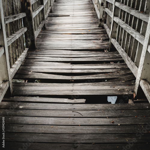Wallpaper Mural Old and broken  wooden bridge path across the lake/river,  selective focus Torontodigital.ca