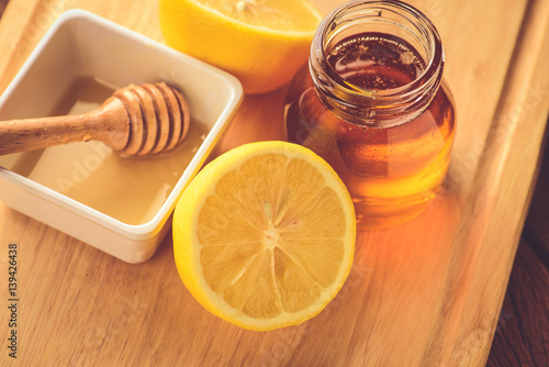 Lemon slice with honey on wood table