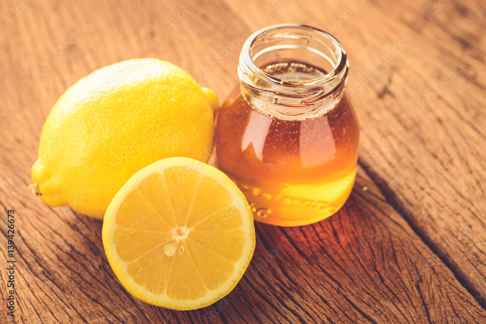 Lemon slice with honey on wood table Lemon slice with honey on wood table