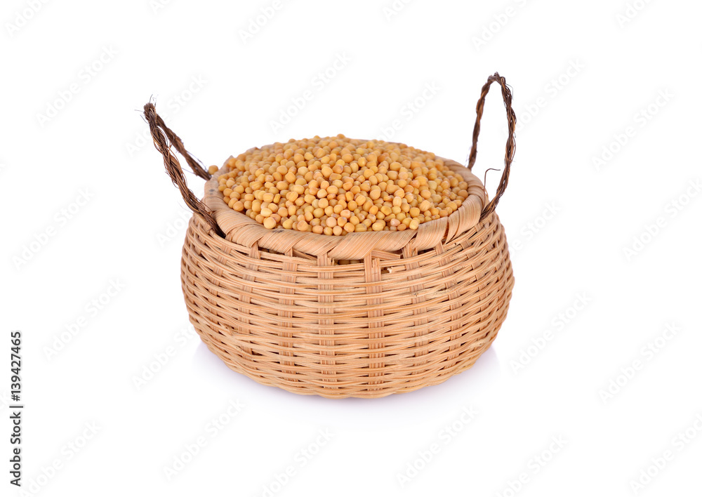 dried mustard seeds in bamboo basket and on white background