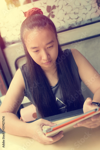 young woman using a digital tablet In restaurants