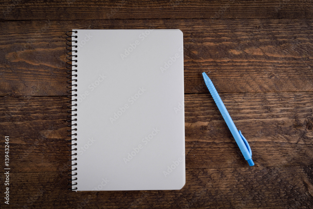 colored pens with a notebook on a wooden background place for text colored pens with a notebook on a wooden background place for text
