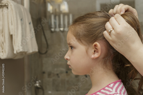 young girl getting her hair fixed