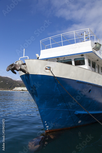 Front view of fresh painted fishing boat  against blue sky