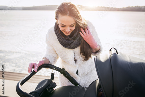 young mother walking with baby, good weather for walking, healthy lifestyle