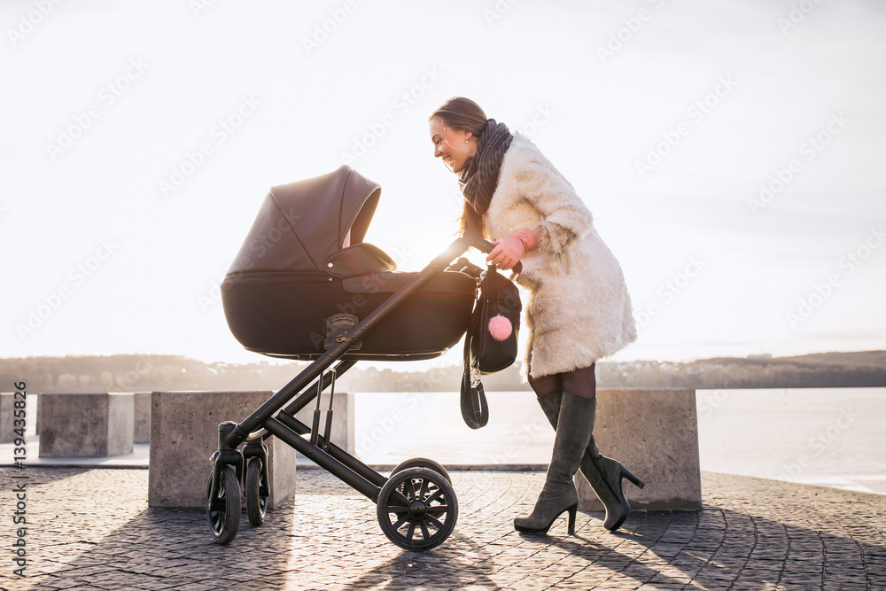 young mother walking with baby, good weather for walking, healthy lifestyle
