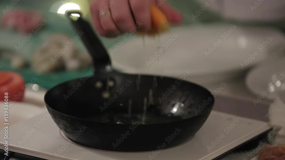 Cook cooking on a kitchen with frying pan Cook cooking on a kitchen with frying pan