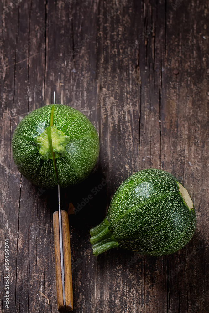 Mini Zucchinis on rustic wooden board cut in halves StockFoto Adobe
