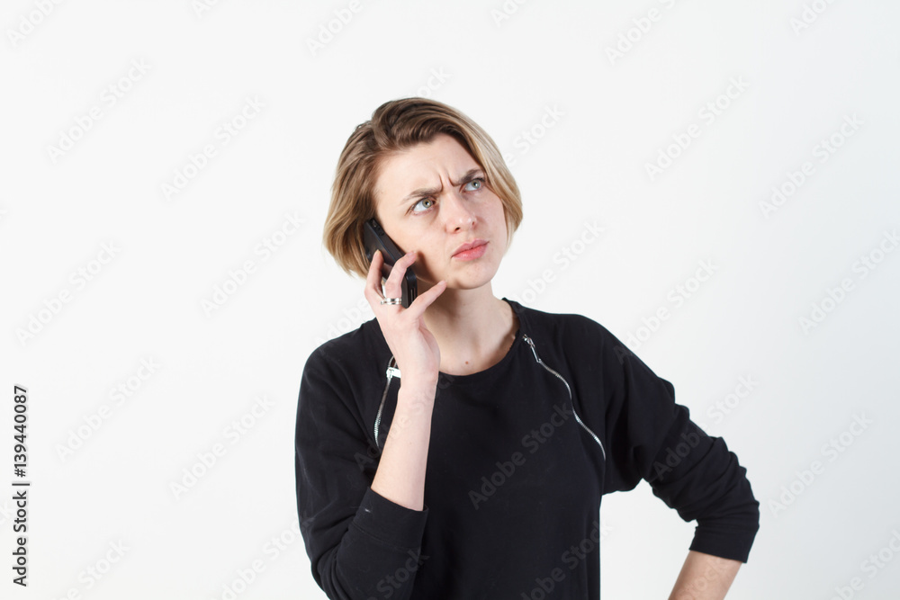 Businesswoman talking on the phone very emotional. She smile, anger, aggression, misunderstood, outrage. On a white background. Happy smiling successful businesswoman with cell phone, isolated on Businesswoman talking on the phone very emotional. She smile, anger, aggression, misunderstood, outrage. On a white background. Happy smiling successful businesswoman with cell phone, isolated on