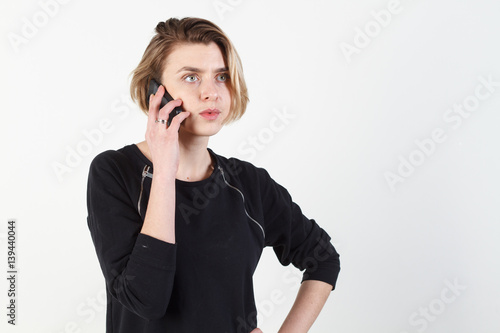 Businesswoman talking on the phone very emotional. She smile, anger, aggression, misunderstood, outrage. On a white background. Happy smiling successful businesswoman with cell phone, isolated on