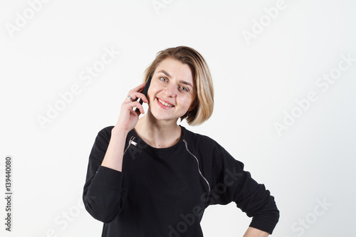 Businesswoman talking on the phone very emotional. She smile, anger, aggression, misunderstood, outrage. On a white background. Happy smiling successful businesswoman with cell phone, isolated on