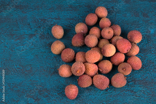 Lychee on a blue cement background photo