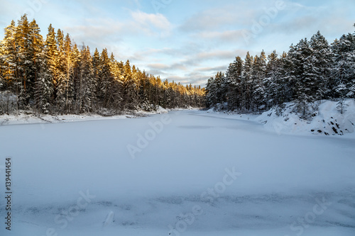 Frozen lake with surrounding forest © Kilman Foto