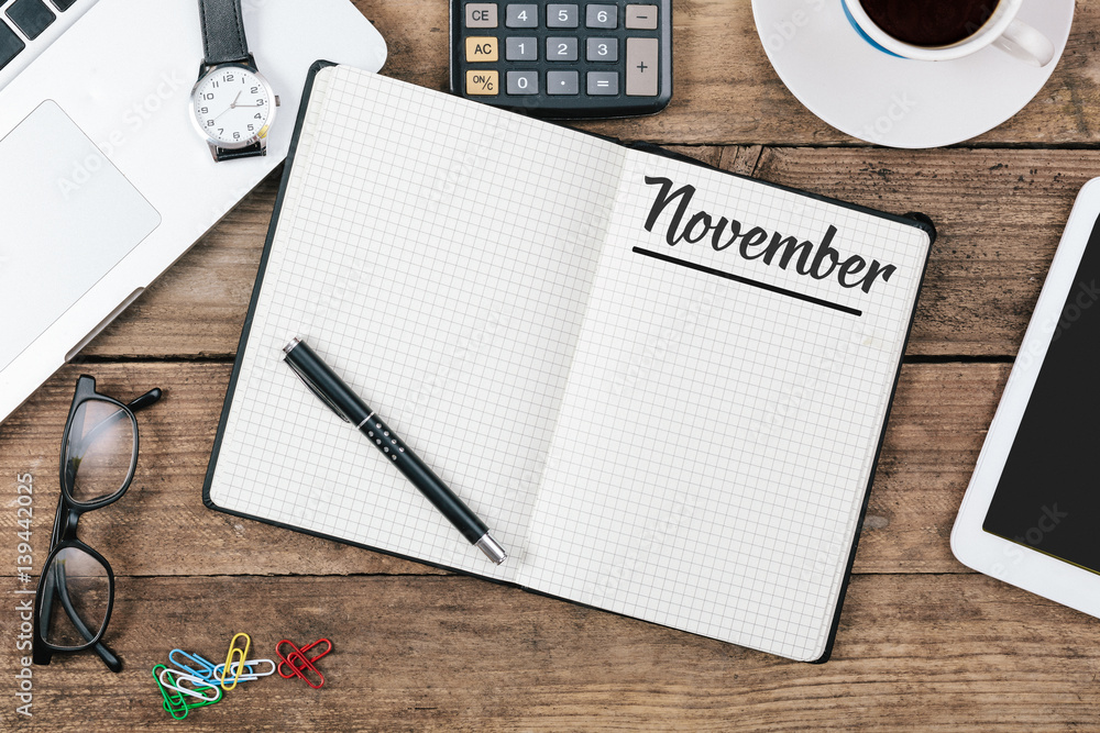 November (German and English) month name on paper note pad at office desk November (German and English) month name on paper note pad at office desk