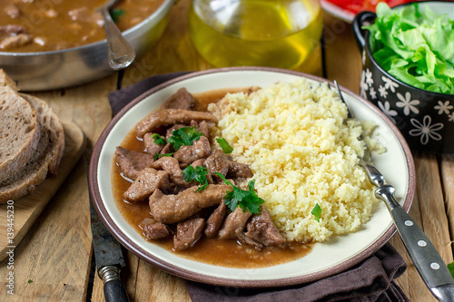 Fotografie Pork fricassee stew in tomato sauce with semolina