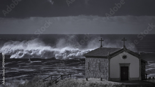 Chapel near stormy sea © Zacarias da Mata