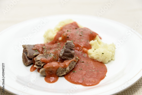 Homemade tomato sauce with mashed potatoes and boiled beef
