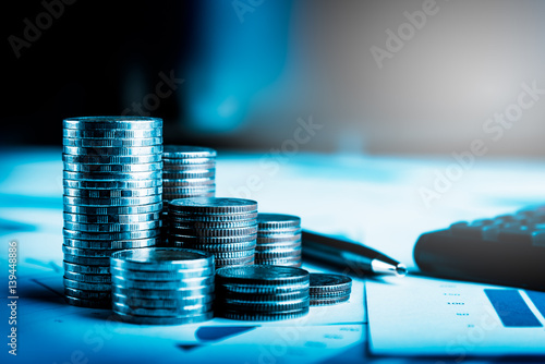 Row of coins,car remote and pen on account book in car finance and banking concept photo