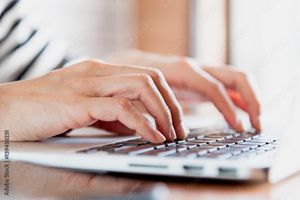 Business women work with laptop,pen and notebook on the wooden table in business and working concept Business women work with laptop,pen and notebook on the wooden table in business and working concept