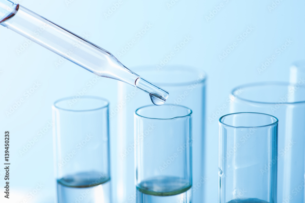 dropping chemical liquid to test tubes, laboratory research and development concept.science background. dropping chemical liquid to test tubes, laboratory research and development concept.science background.