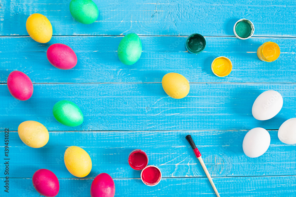 Colorful easter eggs on blue rustic wooden background