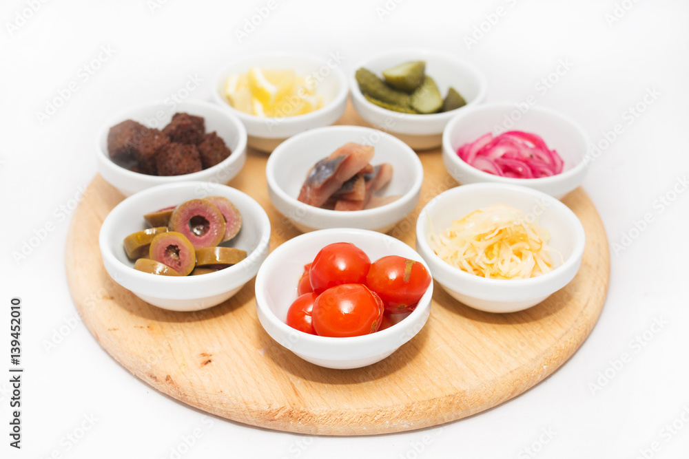 Appetizers in small plates on white background