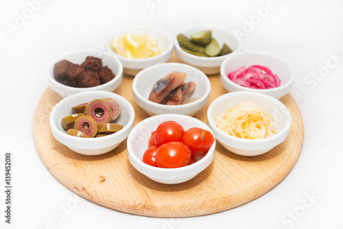 Appetizers in small plates on white background