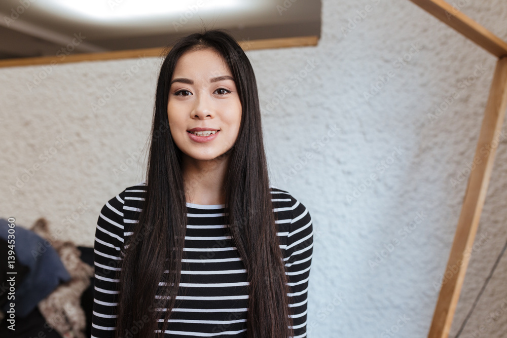 Smiling Asian woman in cafeteria