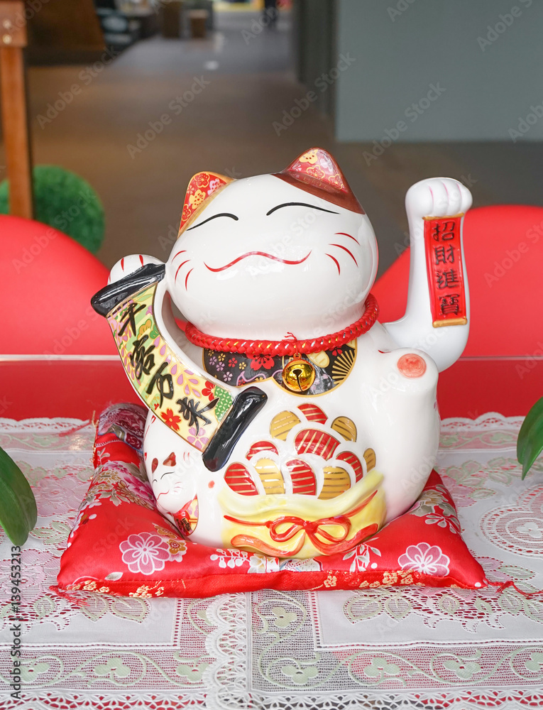 Japanese lucky cat also known as maneki neko. Usually maneki neko cat