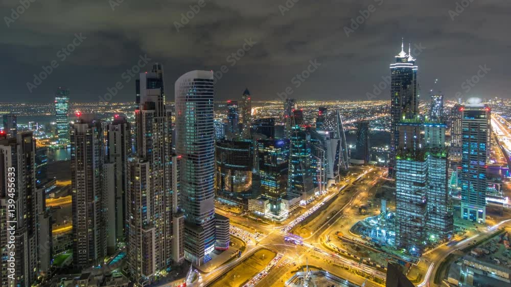 Dubai business bay towers illuminated at night timelapse. Rooftop view of some skyscrapers and new towers under construction. Dubai business bay towers illuminated at night timelapse. Rooftop view of some skyscrapers and new towers under construction.