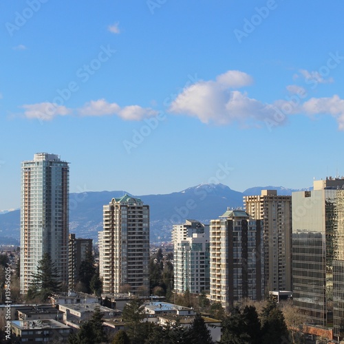 City landscape with high rises and mountains
